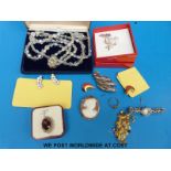 A collection of costume jewellery including a cameo, a watch, beads,