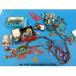 A collection of jewellery to include amber necklace, silver brooch,