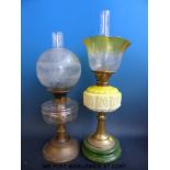 Two glass and brass oil lamps, one with yellow embossed glass,