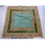 A late Victorian bed cover in dark green brocade and velvet with tapework decoration to the border