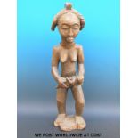 An African tribal Baule maternity figure of a woman holding a child,