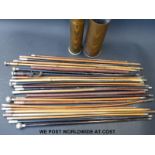 Approximately 25 military and other swagger sticks contained in two shell cases,