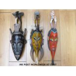 Three African tribal masks with birds to the top and two painted probably Senufo tribe,