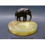 An Art Deco bronze elephant and onyx pin tray