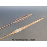 An African metal spear with engraved decoration and flared end (length 138cm) and a similar spear