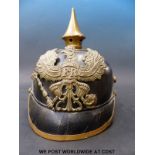 A German late 19thC pickelhaube helmet with embossed insignia and motto 'mit gott fur koenig und