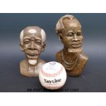 A pair of carved African soapstone busts and a Seoul Olympics baseball