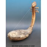 An African tribal figural musical string instrument (length 49cm)