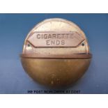 A brass and copper wall mountable cigarette ends holder