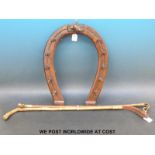 A mahogany whip rack in the form of a horseshoe with fox head carving,