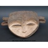 An African tribal mask in the form of two faces (length 17cm)