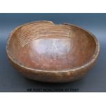 A 19thC carved African bowl with sieve ridges