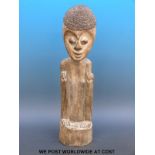 An African tribal figure of a man crouching with rope hair (49cm tall)