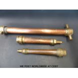 Two fire service type nozzles and a further copper and brass pipe