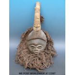 An African tribal Dan mask with raffia surround (length 42cm)