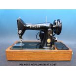 A Singer electric sewing machine in case