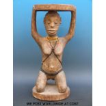 An African figural tribal stool with a kneeling female figure supporting the seat and bead