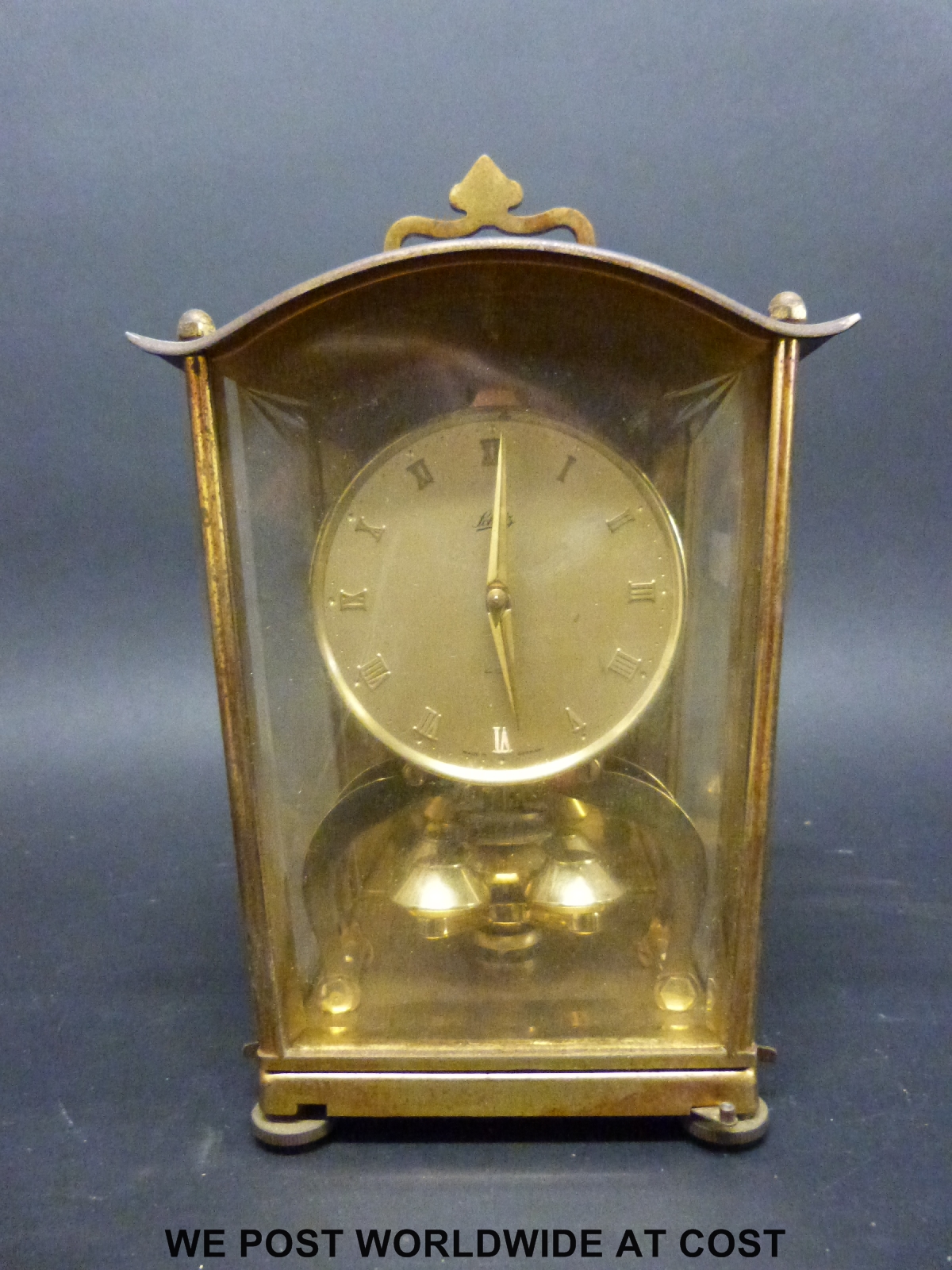 A brass cased German anniversary clock by Schatz, with self colour dial bearing Roman numerals,