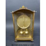 A brass cased German anniversary clock by Schatz, with self colour dial bearing Roman numerals,