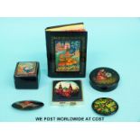 A collection of hand-painted Russian lacquer ware boxes, notebook,