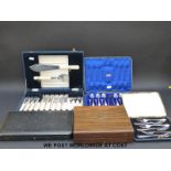 A collection of cased plated cutlery including fish servers,