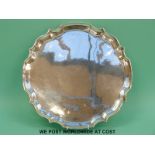 A hallmarked silver tray with shaped edge, Birmingham 1969, diameter 35.
