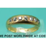 An 18ct gold ring set with seven old cut diamonds (size Q)