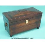 A rosewood or similar exotic wood tea caddy with two divisions flanking a mixing bowl