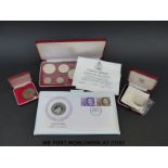 A Commonwealth of the Bahamas sterling silver coin set together with a St Helena crown,