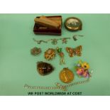 A collection of costume jewellery to include a silver and tigers eye brooch, silver charm bracelet,