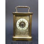 A late 18th/early 20thC brass cased carriage clock with ivory coloured enamel chapter ring,