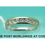 An 18ct gold half eternity ring set with eleven diamonds (size M)