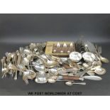 A large quantity of silver plated cutlery to include a quantity of rat tail design and a toast rack