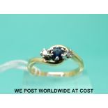 An 18ct gold ring set with a sapphire and diamonds in a platinum setting (size O)