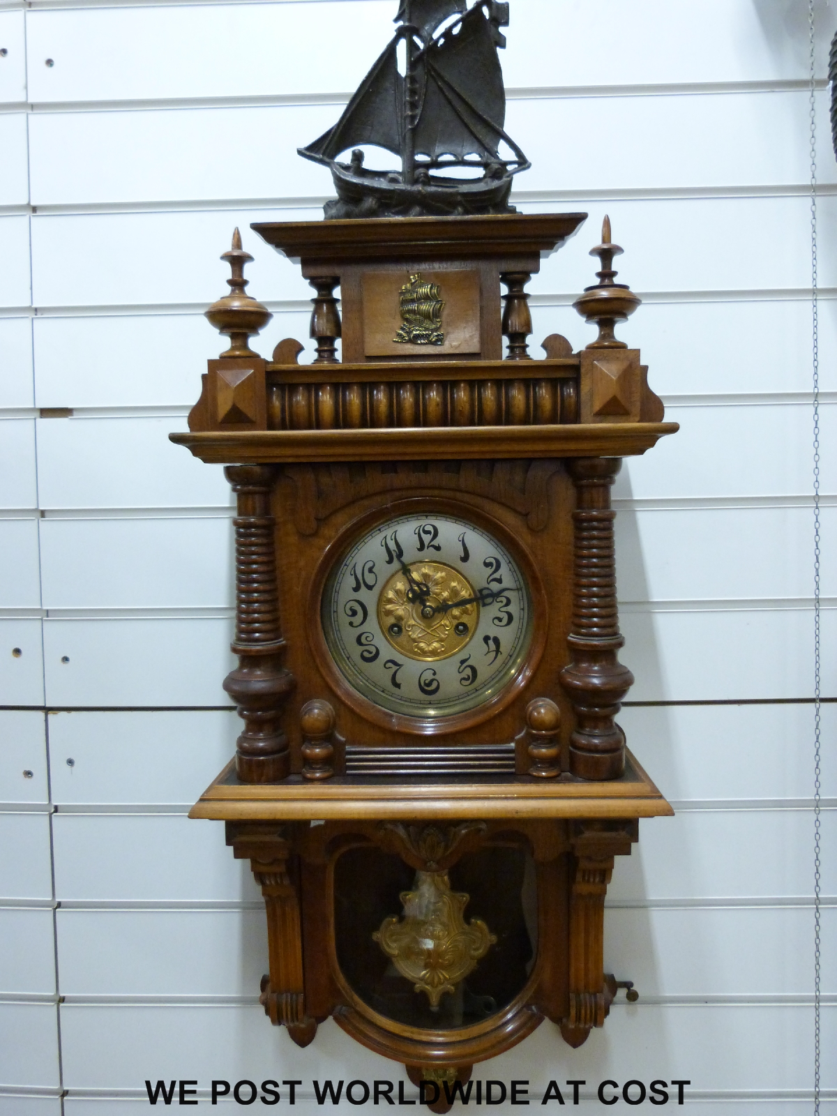 A German wall clock with carved decoration to case, sailing ship finial,