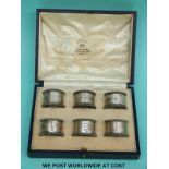 A cased set of six Mappin & Webb hallmarked silver napkin rings and a further single silver napkin