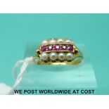 A 15ct gold ring set with seed pearls and rubies (size L)