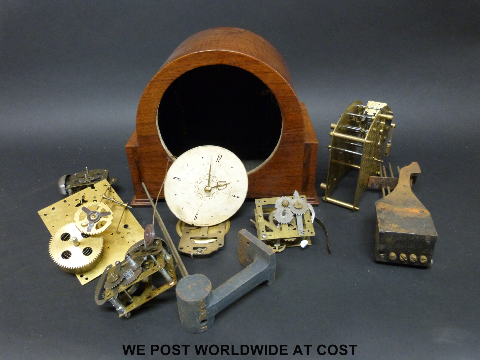 A box of clock parts to include an empty case, gongs, pendulum,