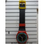 A multicoloured Swatch wall watch in box (26cm diameter dial)