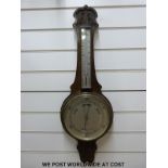 An early 20thC oak cased banjo barometer with carved decoration and thermometer,