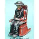 A novelty cruet formed as an Amish/Quaker man on a rocking chair (H8.