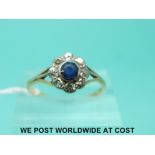 An 18ct gold ring set with a sapphire surrounded by diamonds (size P)