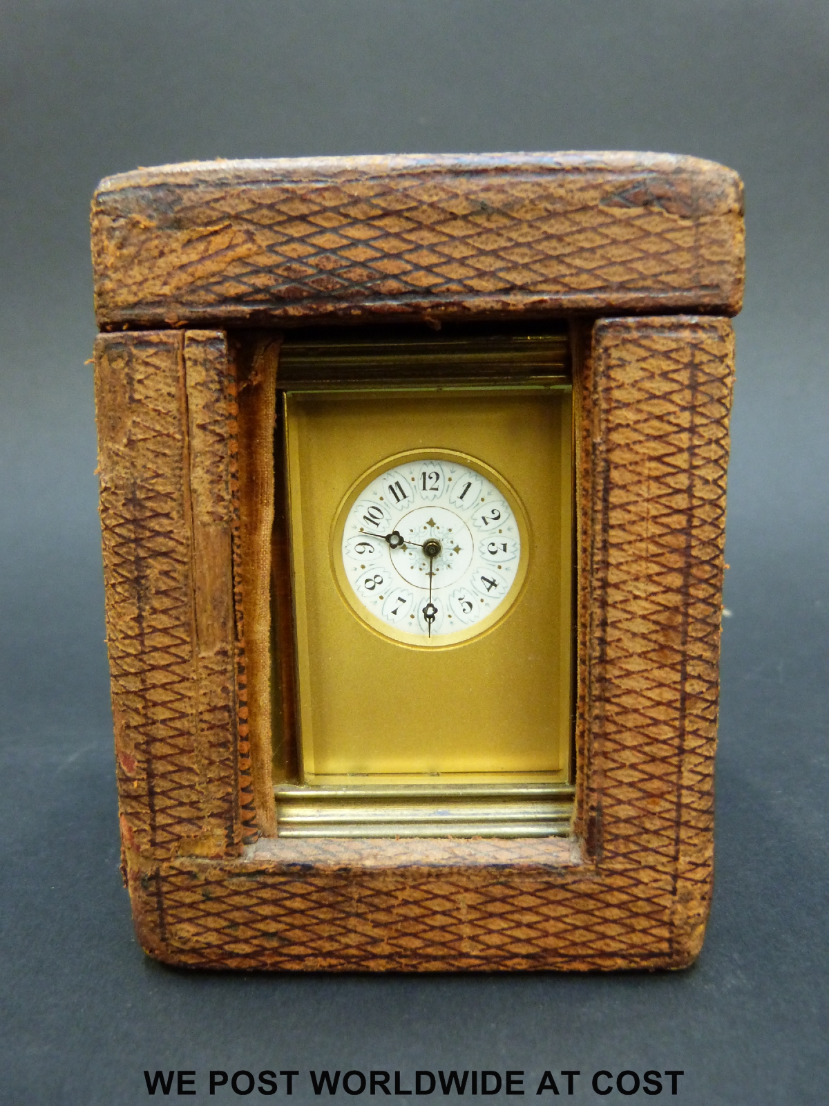 A brass cased miniature carriage clock in corniche style case with inset circular decorated