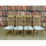 Four upholstered light oak chairs