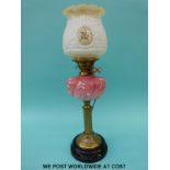 A late 19th / early 20thC brass and glass oil lamp converted to electricity with pink relief