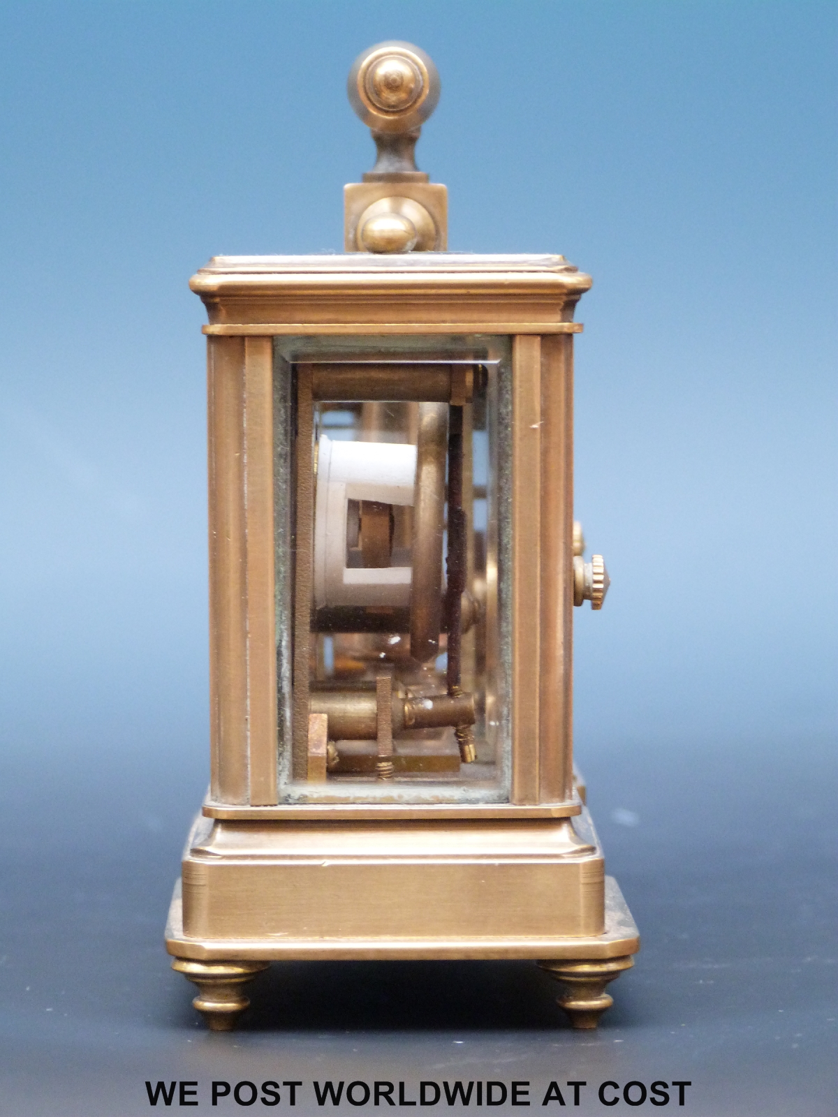 A brass cased miniature carriage clock and barometer compendium with enamelled dials,