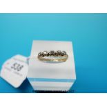 A yellow metal ring marked 18ct set with five diamonds size K (1.