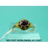 A Victorian yellow metal ring set with an amethyst in a pierced setting (size N)