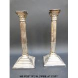 A pair of silver plated Corinthian column candlesticks (height 32cm)