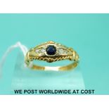 An 18ct gold ring set with a sapphire and four diamonds (size N)